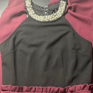 One piece formal wear. Jeweled neckline halter top with long flare pant bottoms.